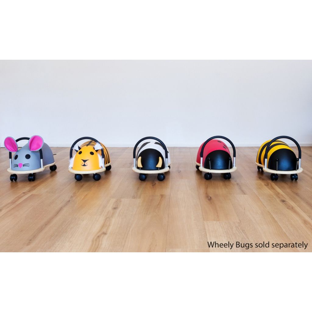 Close-up of the soft, wipe-clean padded cover with black spots on the Wheely Bug small ladybug ride-on